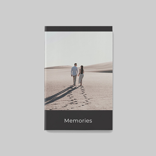 A4 portrait softcover photobook with modern black AI theme showing personalised photos, dark elegant layouts and modern print design.