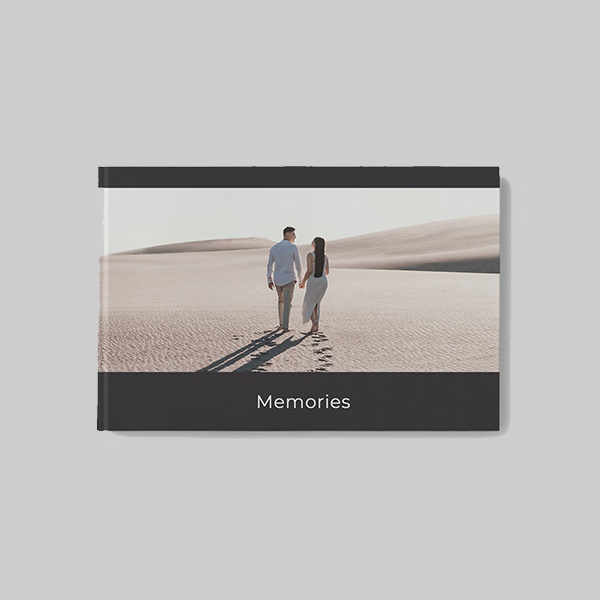 Landscape hardcover photobook with modern black AI theme showing personalised photos, sleek dark layouts and premium hardcover finish.