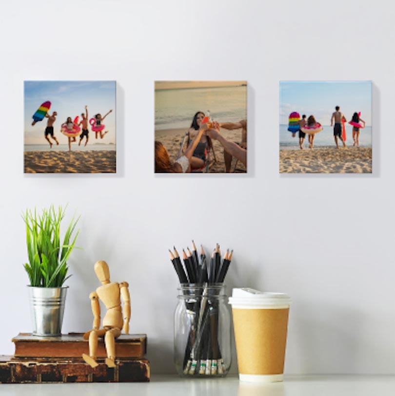 Set of 3 personalised 100x100mm stretched canvas photo prints displayed together on wall