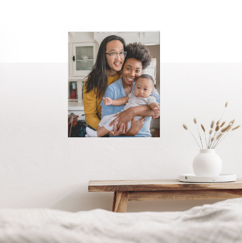200x300mm stretched canvas print with photo of mother, father, and baby family portrait smiling together