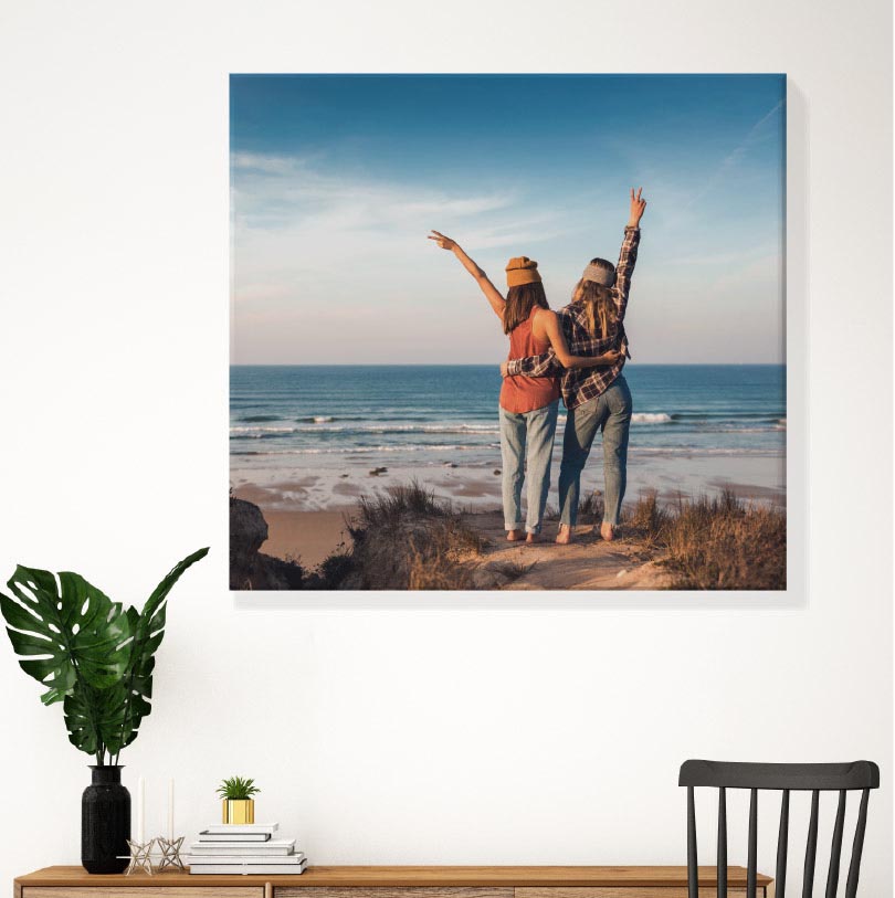 600x600mm stretched canvas print with photo of two friends at the beach smiling and enjoying the seaside