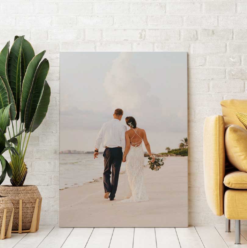600x900mm stretched canvas print with wedding couple walking on beach at sunset holding hands