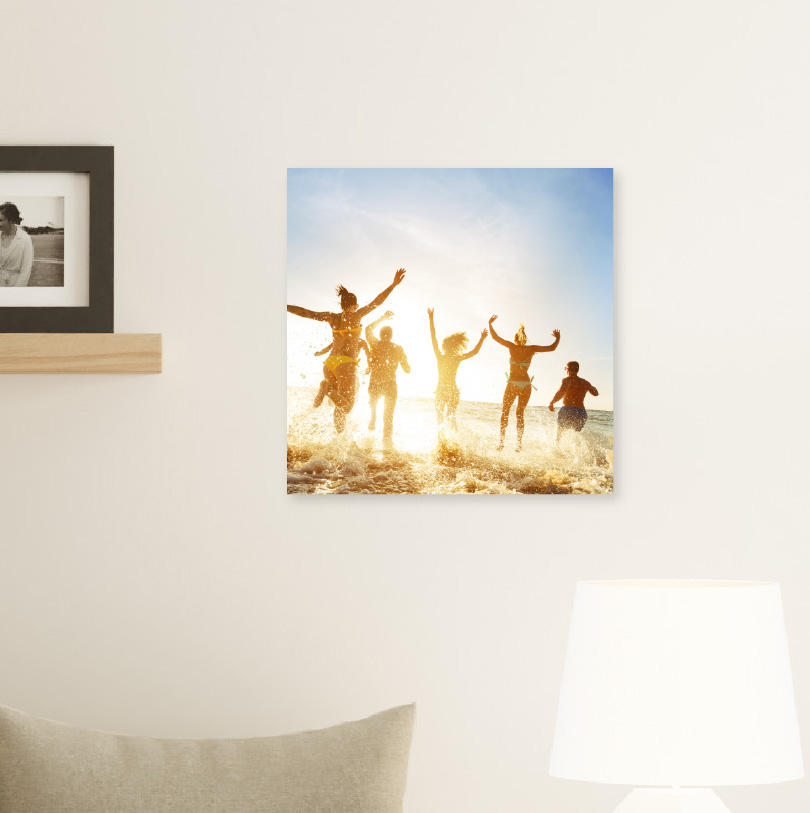 300x300mm foam board print with photo of family jumping in ocean water during beach vacation