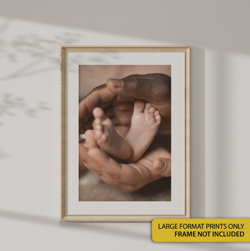 300x450mm large format print with photo of mother’s hands gently holding baby’s feet in a soft emotional portrait