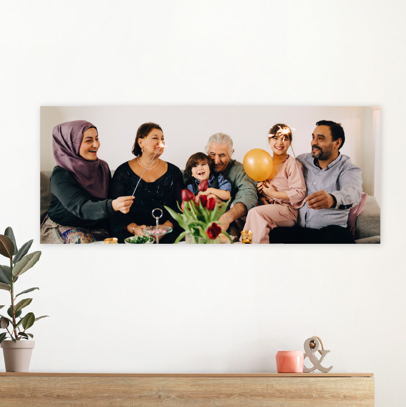 300x900mm foam board print with photo of family sitting between flowers and balloons celebrating together