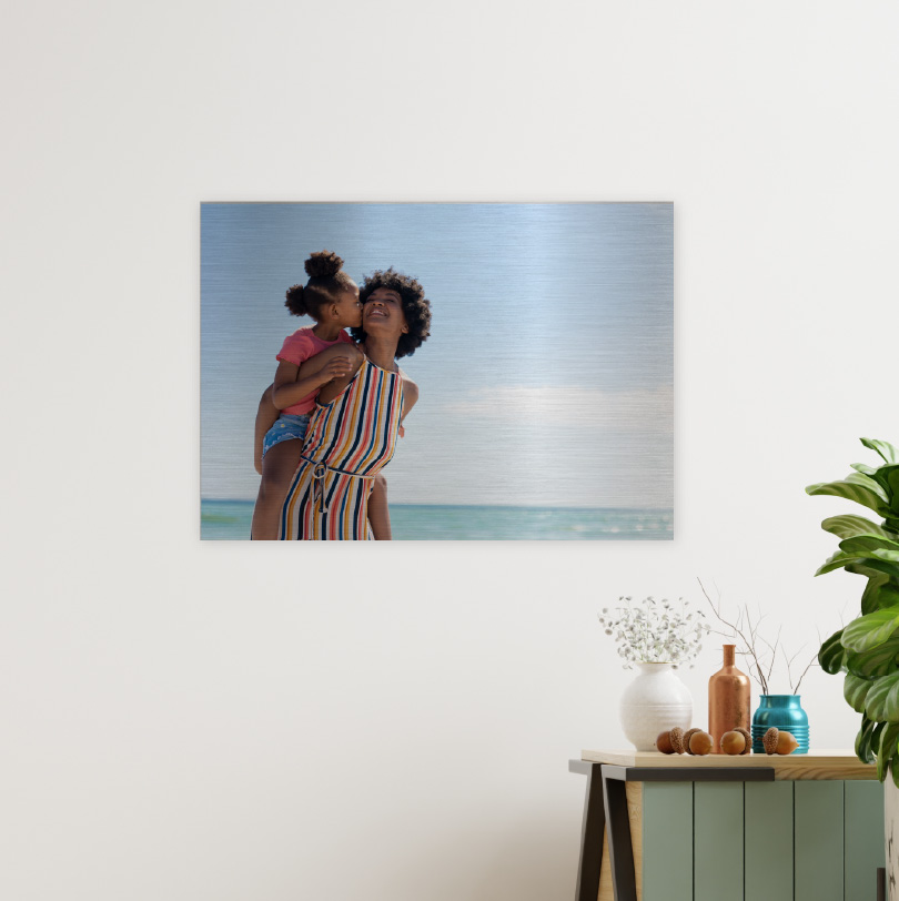 400x600mm brushed silver aluminium print with photo of mother carrying daughter on her back at the beach