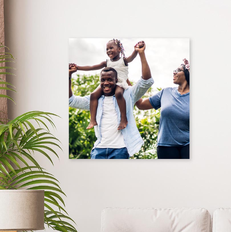 500x500mm foam board print with photo of family and dad carrying daughter on shoulders happily outdoors
