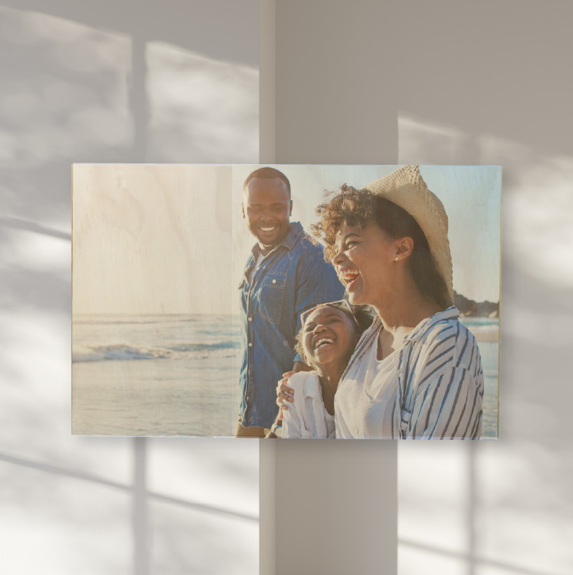 500x750mm birch wood photo print showing parents and daughter on beach on natural wooden panel