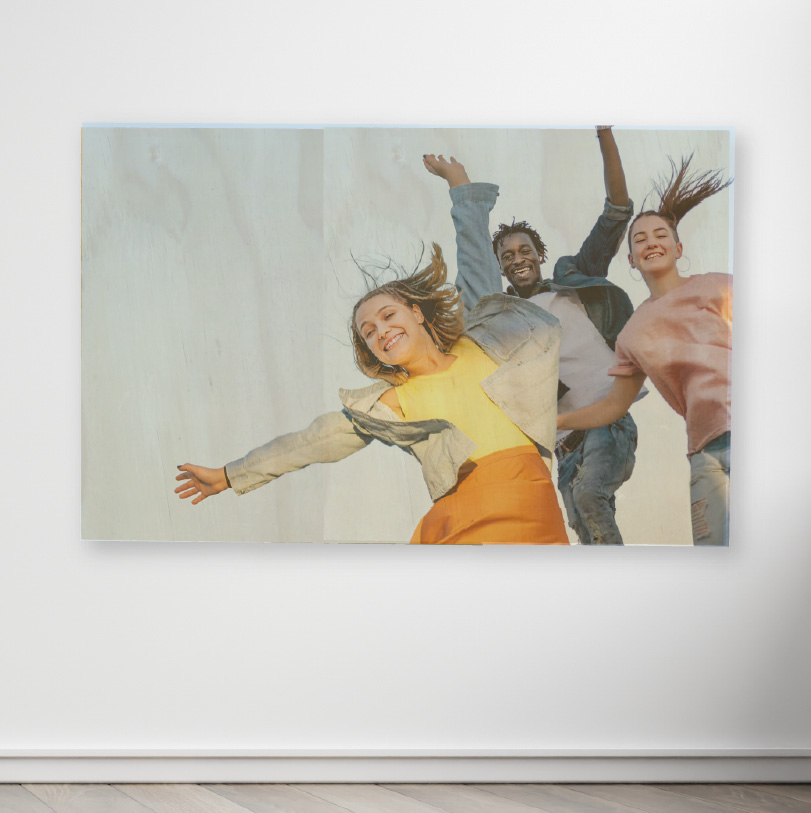 600x800mm birch wood photo print showing three friends jumping on natural wooden panel