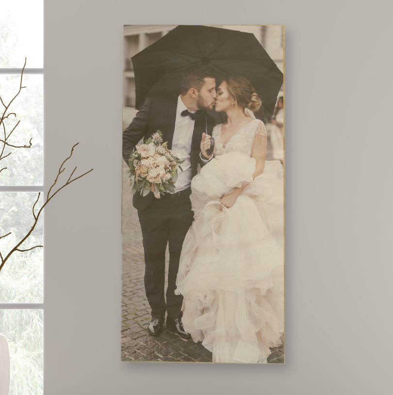 900x300mm birch wood photo print showing happy wedding couple under umbrella on natural wooden panel