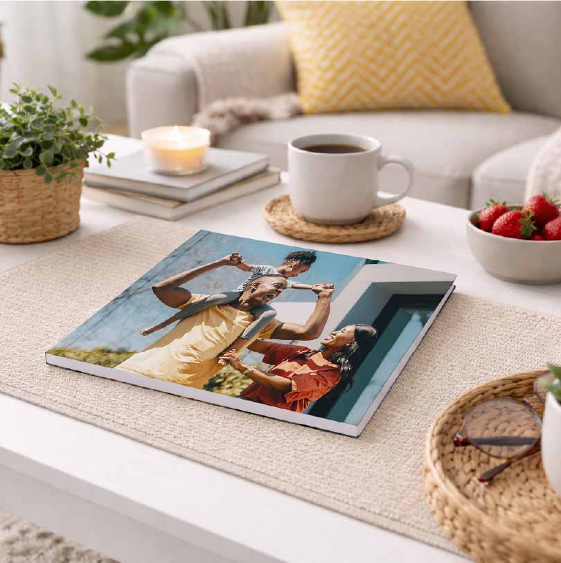 200x200 personalised glue bound softcover photobook with family photo on cover displayed on table