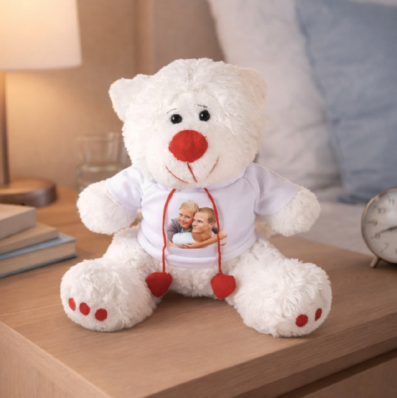 Brown teddy bear wearing a mini shirt printed with a photo of a young couple.