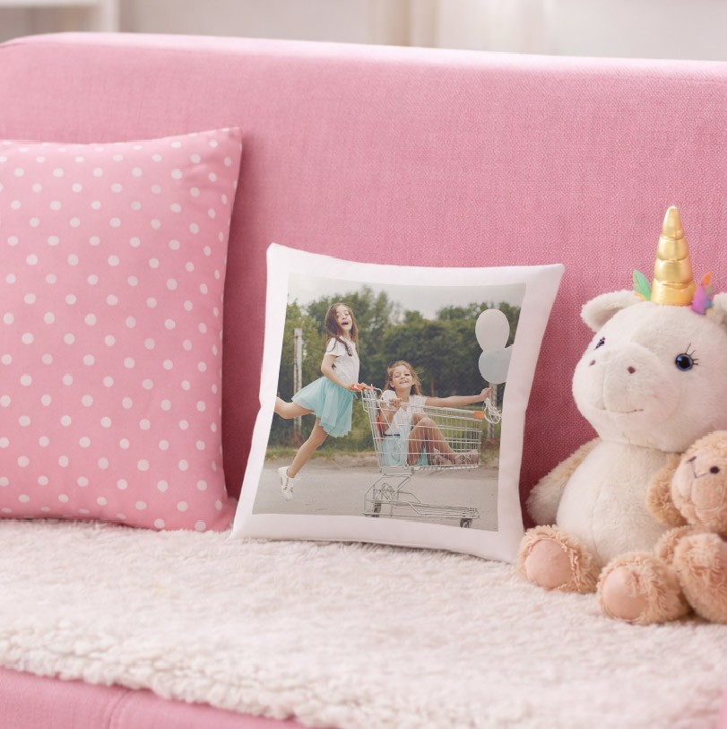 250x250mm cushion printed with a photo of two little girls playing with a shopping trolley.