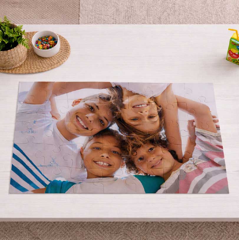 Kids puzzle printed with a photo of four smiling siblings together.