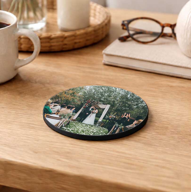 Round coasters printed with a photo of a wedding ceremony couple on their special day.