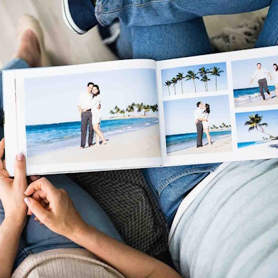 Couple viewing a custom landscape photobook filled with photos