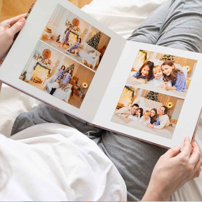 Happy family looking at a 300x300 personalised hardcover photobook
