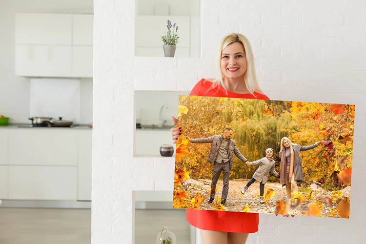 Woman holding a custom canvas print with a family photo in her hands