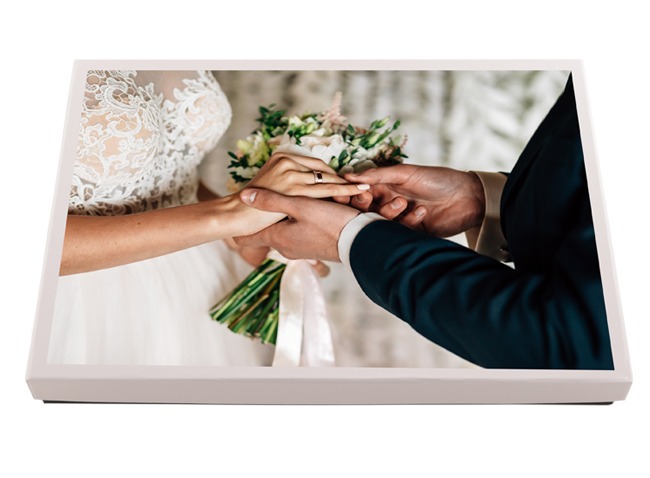 Personalised photo box printed with bride and groom exchanging rings during their wedding ceremony, ideal for storing wedding photo memories.