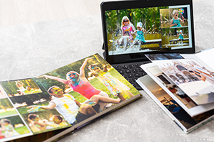 Photobooks next to an iPad on a table